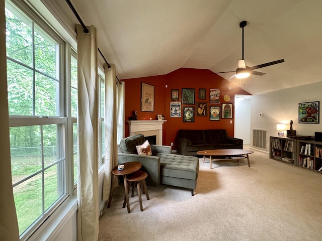 130 Jordan Ln, Hohenwald, TN 38462 - carpeted living area with vaulted ceiling, a ceiling fan, and a fireplace