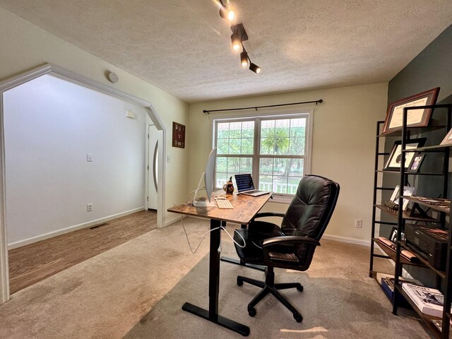 130 Jordan Ln, Hohenwald, TN 38462 - carpeted office space featuring a textured ceiling and baseboards