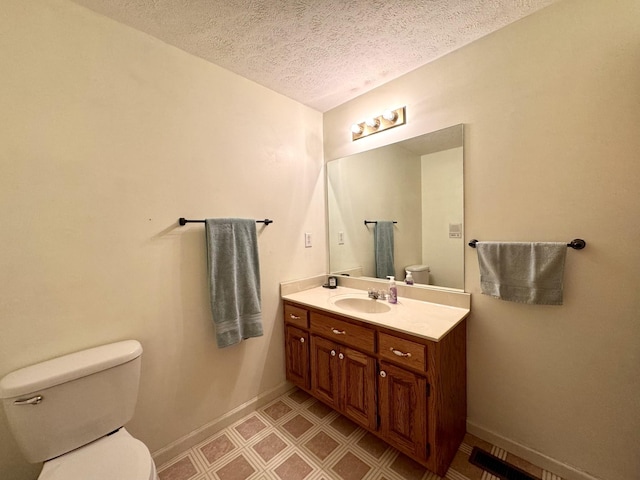 130 Jordan Ln, Hohenwald, TN 38462 - half bathroom with toilet, a textured ceiling, baseboards, vanity, and tile patterned floors