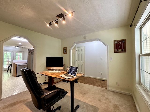 130 Jordan Ln, Hohenwald, TN 38462 - office featuring arched walkways, light colored carpet, a textured ceiling, rail lighting, and baseboards