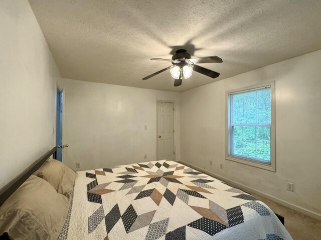 130 Jordan Ln, Hohenwald, TN 38462 - bedroom with a textured ceiling, ceiling fan, baseboards, and carpet floors