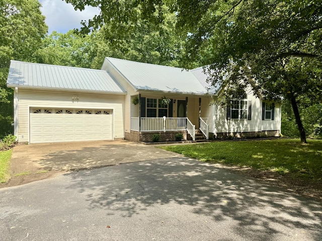 130 Jordan Ln, Hohenwald, TN 38462 - ranch-style house featuring covered porch, driveway, a garage, and metal roof