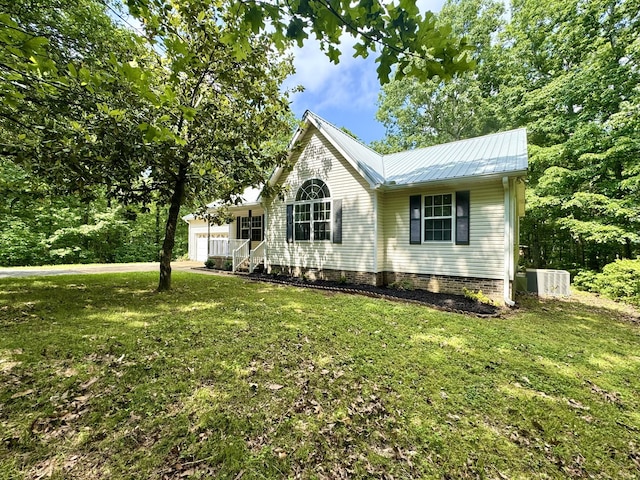 130 Jordan Ln, Hohenwald, TN 38462 - view of front of home with a front lawn, a garage, central AC, and metal roof