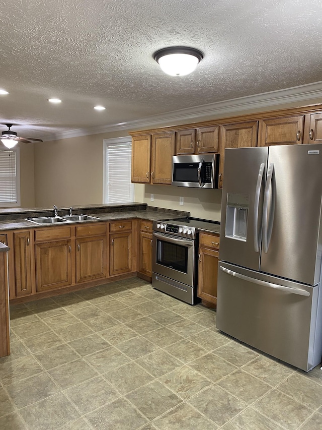 135 Excell Rd Unit 101, Clarksville, TN 37043 - kitchen featuring appliances with stainless steel finishes, a sink, ornamental molding, brown cabinets, and dark countertops