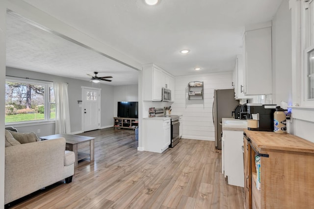 10 Patrick Rd, Fayetteville, TN 37334 - kitchen featuring stainless steel appliances, open floor plan, white cabinets, light wood-type flooring, and recessed lighting