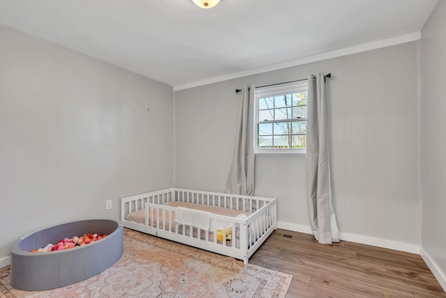 10 Patrick Rd, Fayetteville, TN 37334 - bedroom featuring wood finished floors, baseboards, and a crib