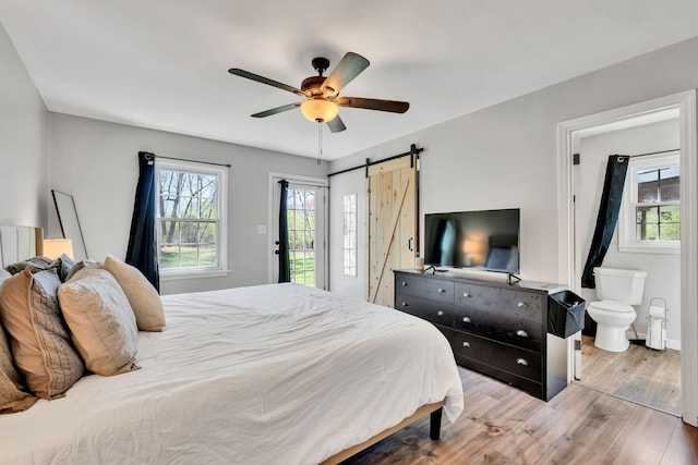 10 Patrick Rd, Fayetteville, TN 37334 - bedroom with multiple windows, wood finished floors, access to exterior, and a barn door