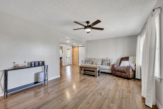 10 Patrick Rd, Fayetteville, TN 37334 - living area featuring a barn door, a ceiling fan, light wood-style flooring, and baseboards
