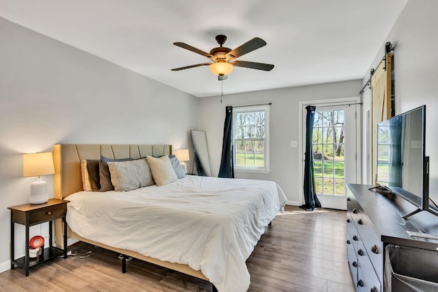 10 Patrick Rd, Fayetteville, TN 37334 - bedroom with wood finished floors, access to exterior, baseboards, and a barn door