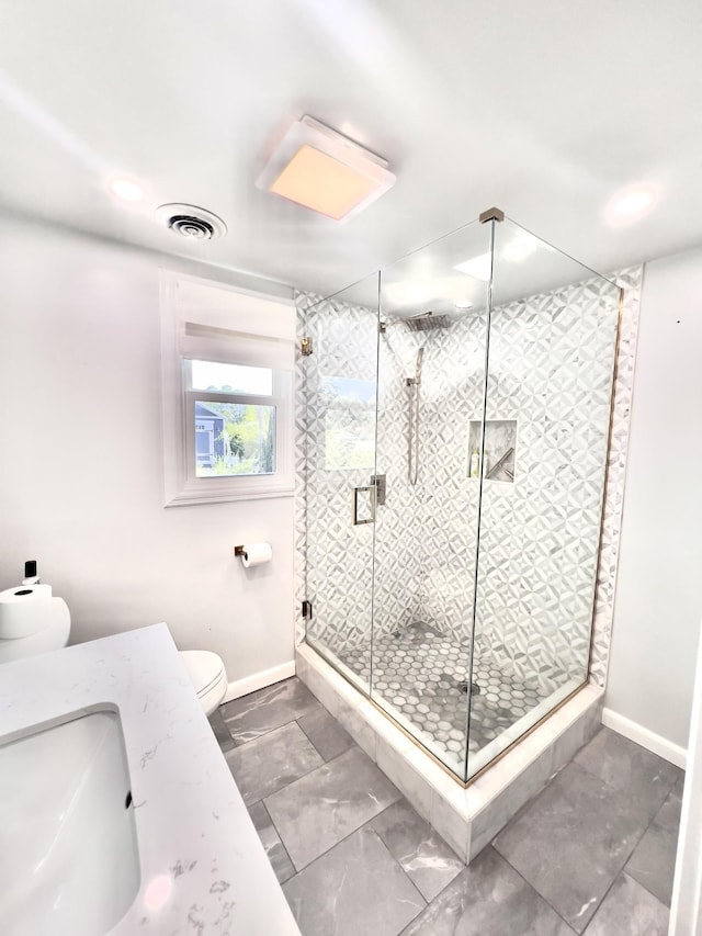 full bath with toilet, baseboards, a shower stall, a sink, and recessed lighting