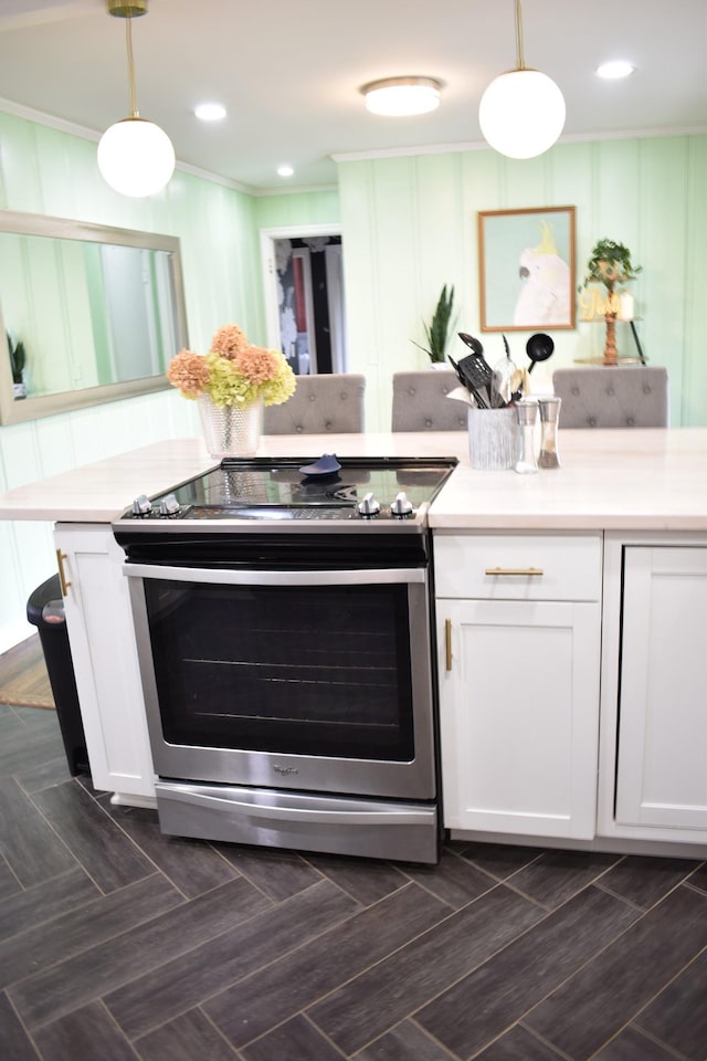 kitchen with stainless steel electric range oven, white cabinets, light countertops, pendant lighting, and crown molding