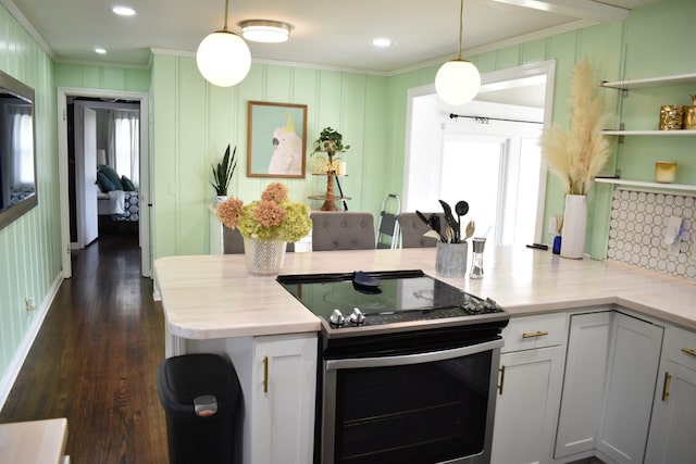 kitchen featuring electric stove, ornamental molding, open shelves, dark wood finished floors, and decorative light fixtures