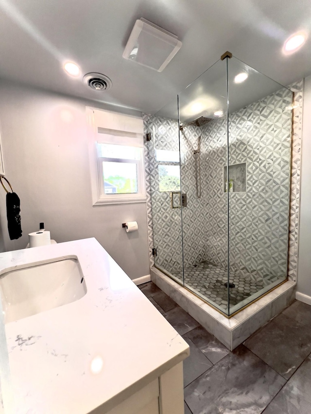 full bathroom with a stall shower, recessed lighting, vanity, and baseboards