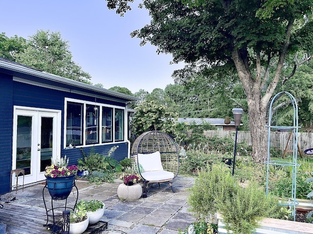 view of patio with french doors and fence