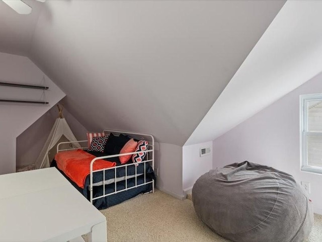 bedroom featuring lofted ceiling, carpet, and a ceiling fan