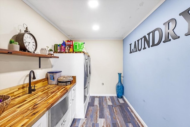 505 Kindel Dr, Decherd, TN 37324 - kitchen featuring butcher block countertops, white cabinetry, dark wood-style flooring, ornamental molding, and baseboards