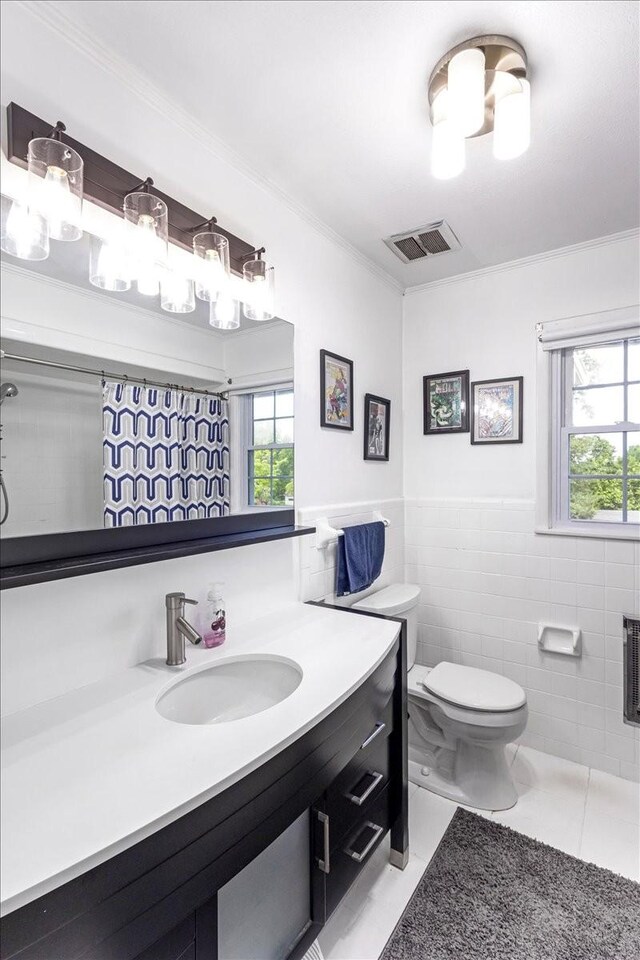 505 Kindel Dr, Decherd, TN 37324 - bathroom featuring crown molding, tile walls, toilet, plenty of natural light, and vanity