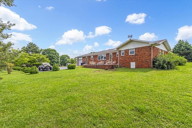 505 Kindel Dr, Decherd, TN 37324 - back of property featuring a yard and brick siding