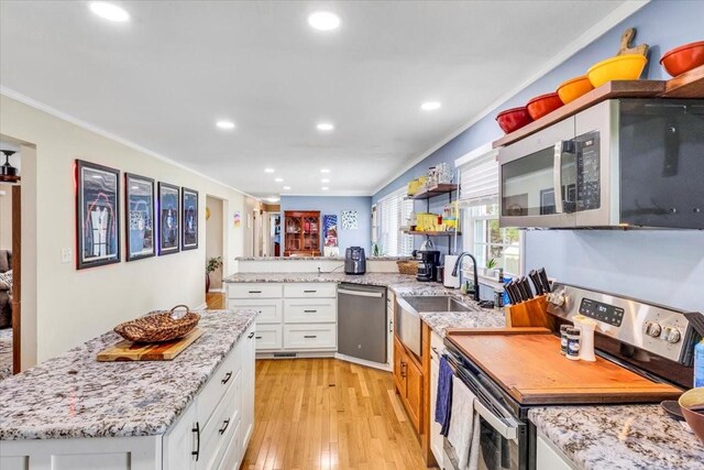 505 Kindel Dr, Decherd, TN 37324 - kitchen featuring stainless steel appliances, crown molding, white cabinets, recessed lighting, and light wood finished floors
