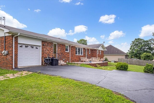 505 Kindel Dr, Decherd, TN 37324 - ranch-style home with asphalt driveway, an attached garage, and brick siding