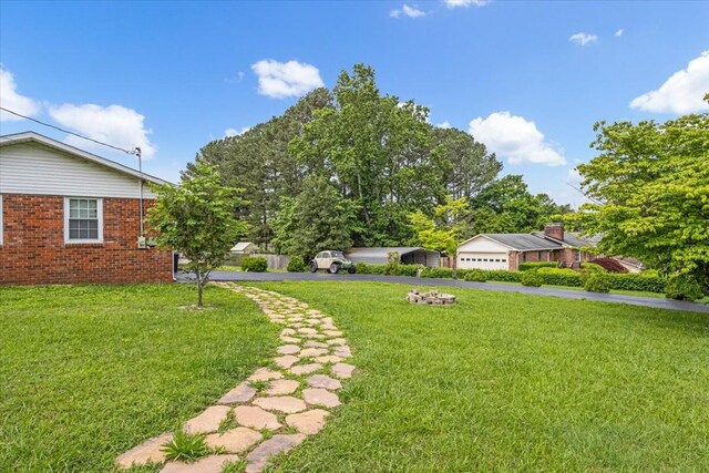 505 Kindel Dr, Decherd, TN 37324 - view of grassy yard with a garage