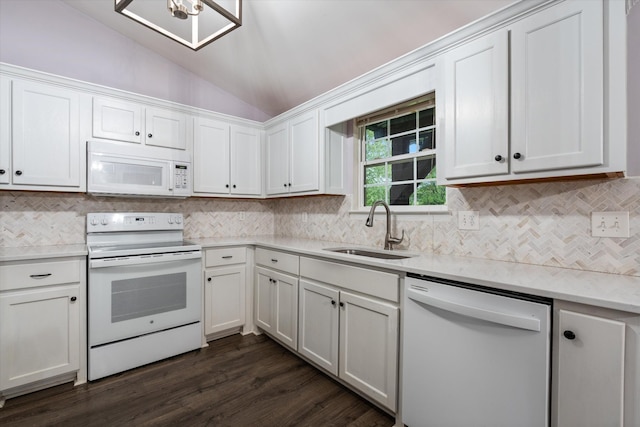 kitchen with white appliances, lofted ceiling, a sink, light countertops, and white cabinetry