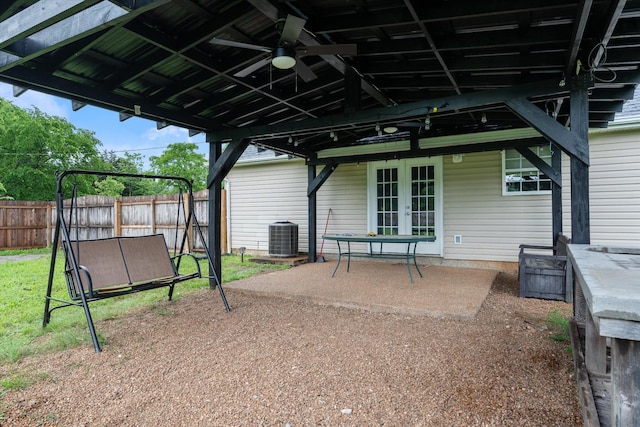 view of patio with french doors, fence, cooling unit, and a ceiling fan