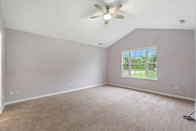 spare room with ceiling fan, carpet flooring, vaulted ceiling, and baseboards