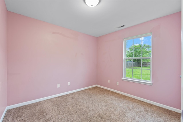 carpeted spare room with baseboards