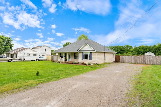 single story home featuring driveway, covered porch, and a shingled roof