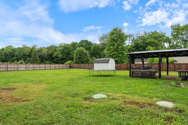 view of yard featuring a gazebo, a shed, and an outbuilding