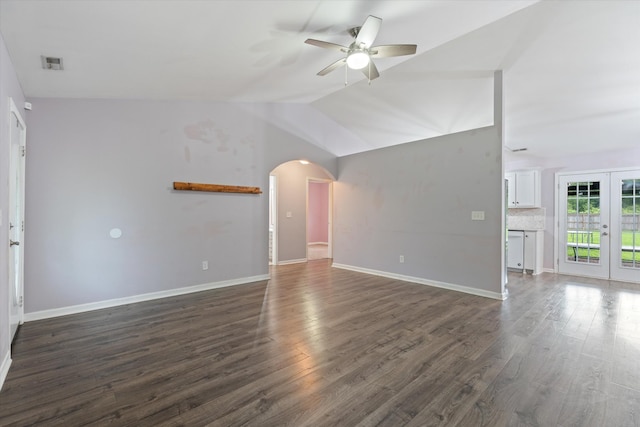 unfurnished living room with a ceiling fan, french doors, dark wood-style flooring, arched walkways, and baseboards