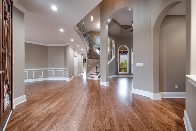 291 Bowling Branch Rd, Cottontown, TN 37048 - entrance foyer with crown molding, ceiling fan, wood finished floors, a decorative wall, and arched walkways