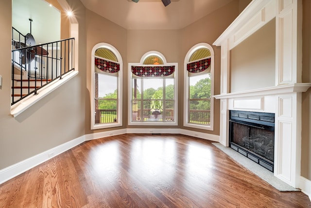 291 Bowling Branch Rd, Cottontown, TN 37048 - unfurnished living room with wood finished floors, a ceiling fan, a fireplace, and baseboards