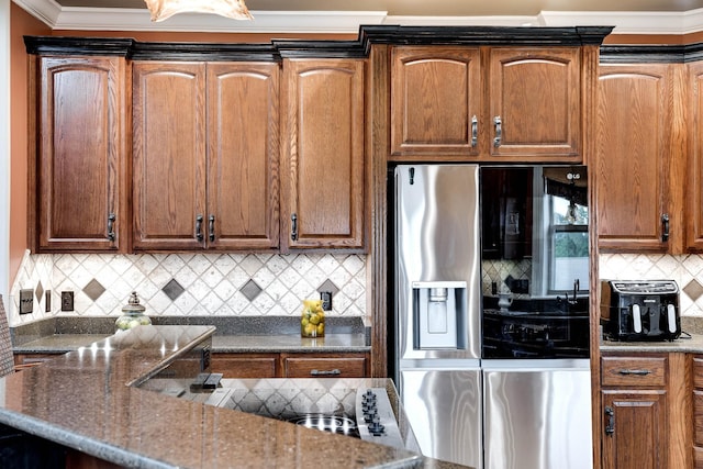 291 Bowling Branch Rd, Cottontown, TN 37048 - kitchen with stainless steel fridge, decorative backsplash, crown molding, black electric cooktop, and dark stone counters