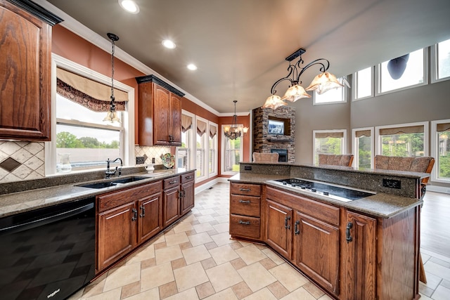 291 Bowling Branch Rd, Cottontown, TN 37048 - kitchen with black dishwasher, a chandelier, electric stovetop, dark countertops, and plenty of natural light