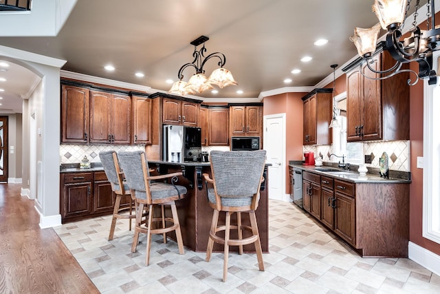 291 Bowling Branch Rd, Cottontown, TN 37048 - kitchen featuring black microwave, refrigerator with ice dispenser, ornamental molding, a center island, and recessed lighting