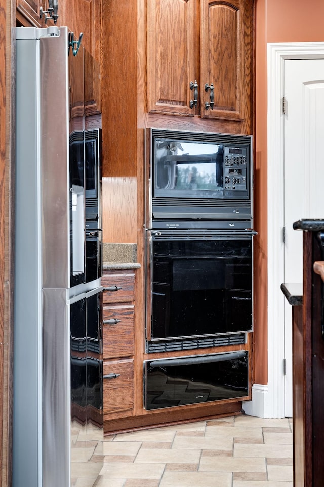 291 Bowling Branch Rd, Cottontown, TN 37048 - kitchen with black appliances, a warming drawer, and brown cabinets