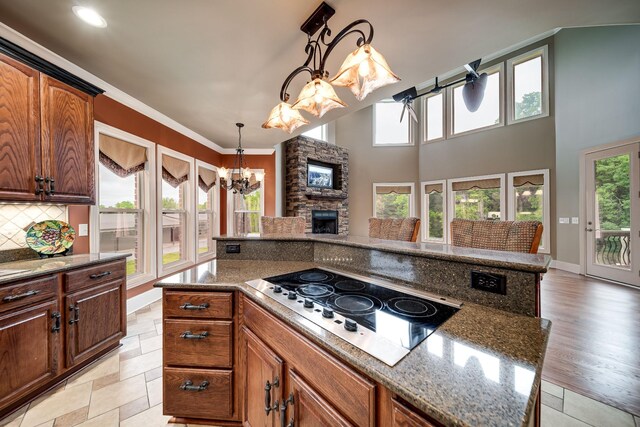 291 Bowling Branch Rd, Cottontown, TN 37048 - kitchen with electric stovetop, a chandelier, plenty of natural light, backsplash, and ornamental molding