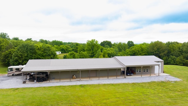 291 Bowling Branch Rd, Cottontown, TN 37048 - back of property featuring a lawn, a forest view, and a carport