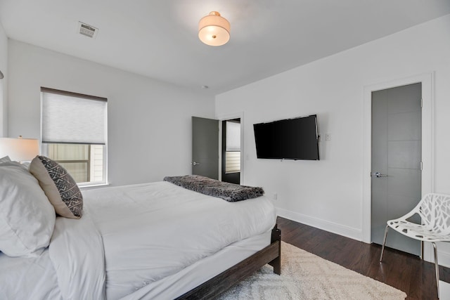 bedroom featuring wood finished floors and baseboards