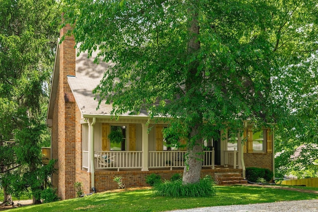 405 Timberlake Dr, Springfield, TN 37172 - obstructed view of property featuring covered porch, a chimney, a front lawn, brick siding, and roof with shingles