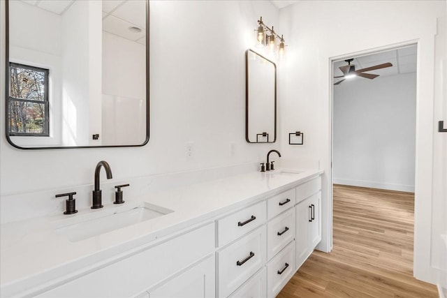 113 Lake Crest Ln, Tullahoma, TN 37388 - bathroom with double vanity, wood finished floors, a ceiling fan, and baseboards