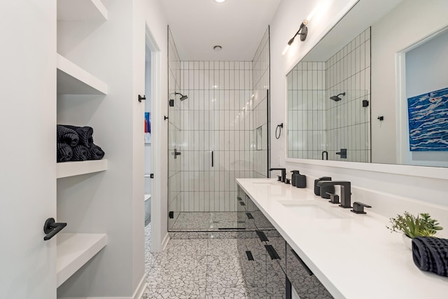 bathroom with a shower stall and double vanity