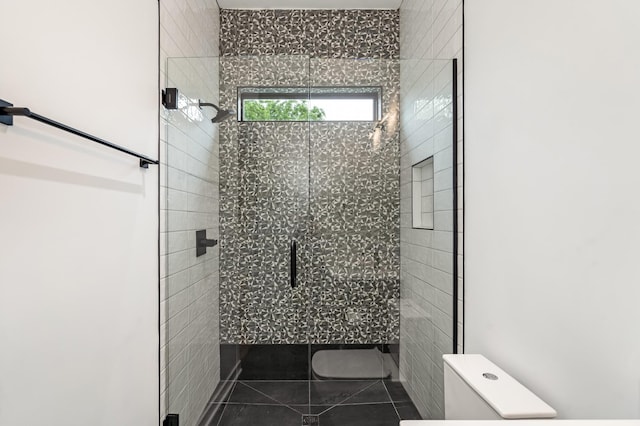 full bathroom with toilet and a stall shower