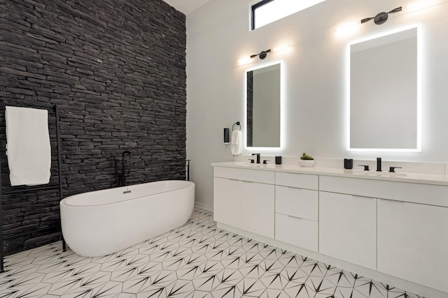 full bath featuring a freestanding tub and double vanity