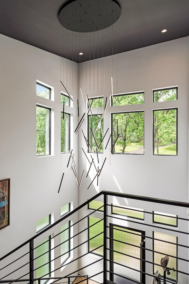 stairway with recessed lighting and a high ceiling