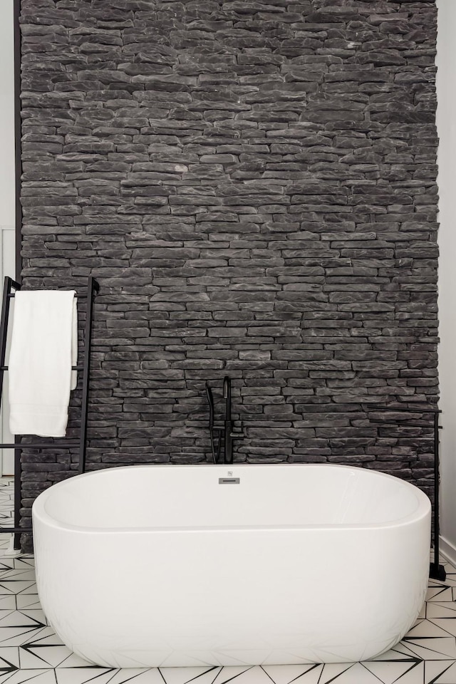 bathroom featuring a freestanding bath and tile patterned floors