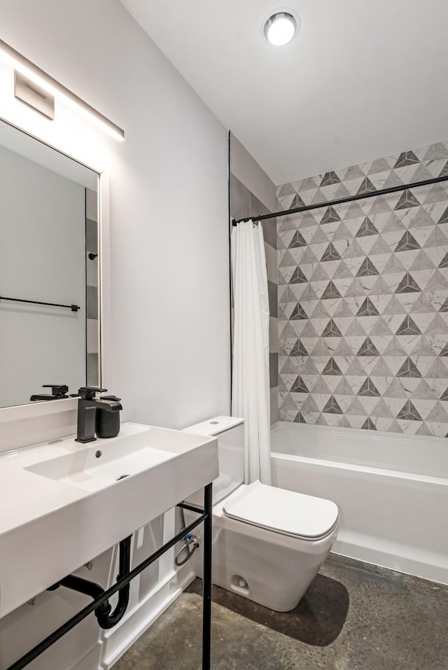 bathroom with toilet, shower / bath combination with curtain, and a sink