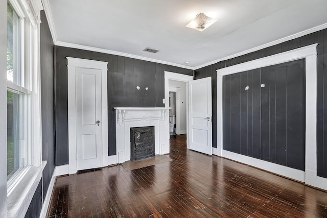 unfurnished living room featuring crown molding, a fireplace with flush hearth, wood finished floors, and baseboards